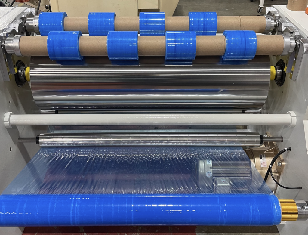 Shrink wrap slitting and rewinding